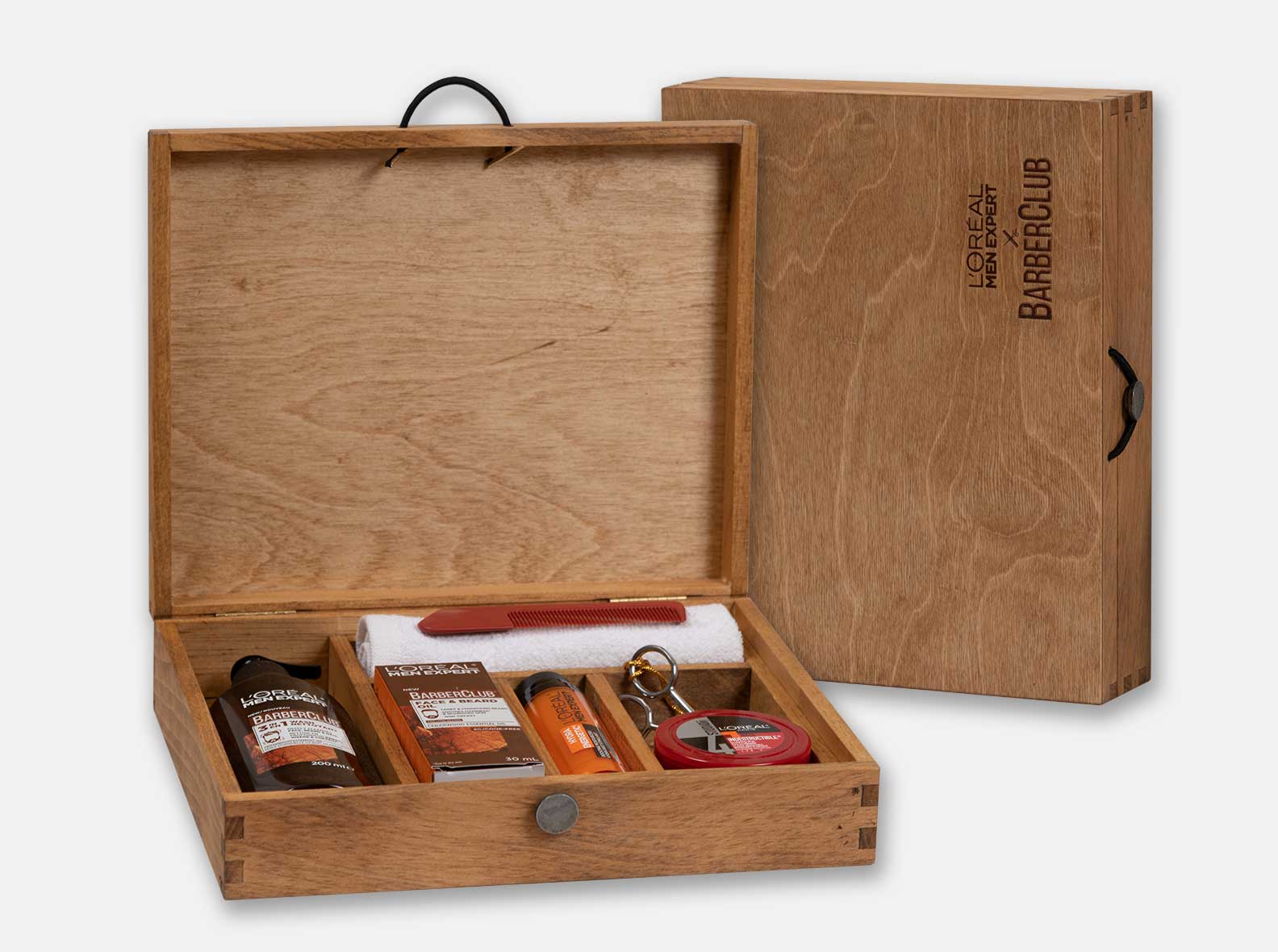 Hinged wooden presentation box with dividers, made for L'Oréal's BarberClub promo kit.