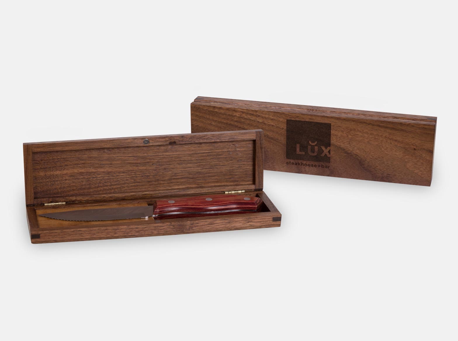 Hinged black walnut steak knife box with a magnetic closure.