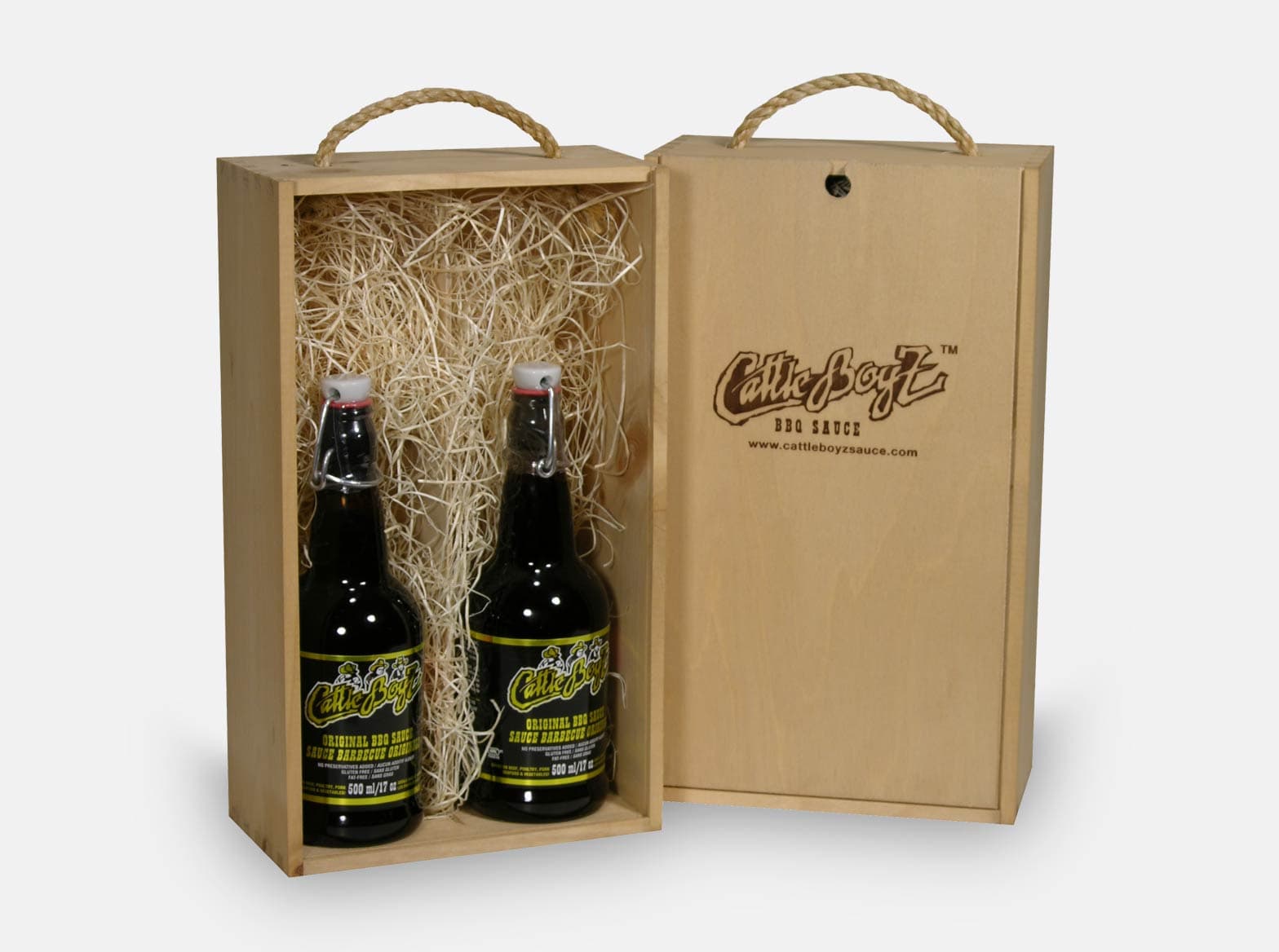 Wooden gift box with a sliding lid and rope handle, made to present BBQ sauce for CattleBoyz.