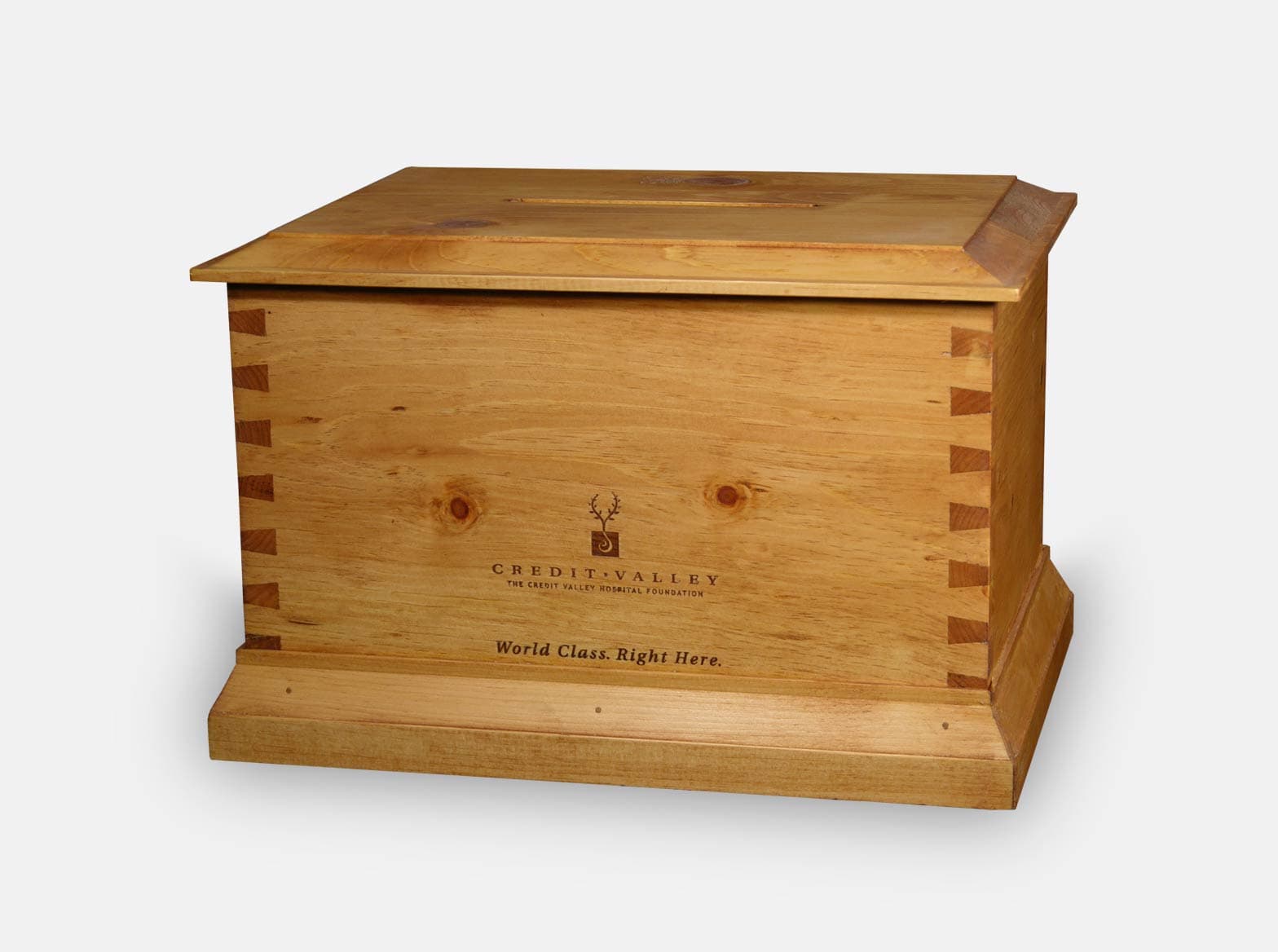 Wooden donation box with a dovetail design and envelope slot, made for a hospital foundation.