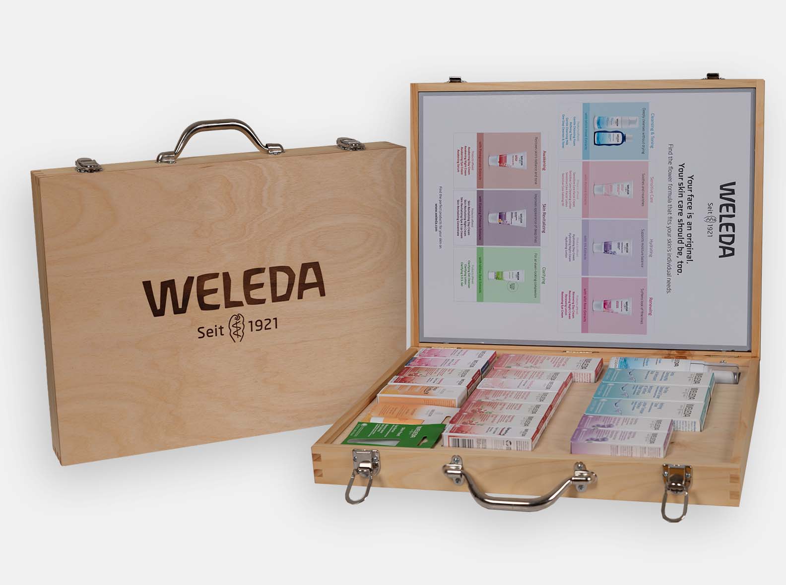 Wooden briefcase-style sales box with a metal handle, made for Weleda skincare.