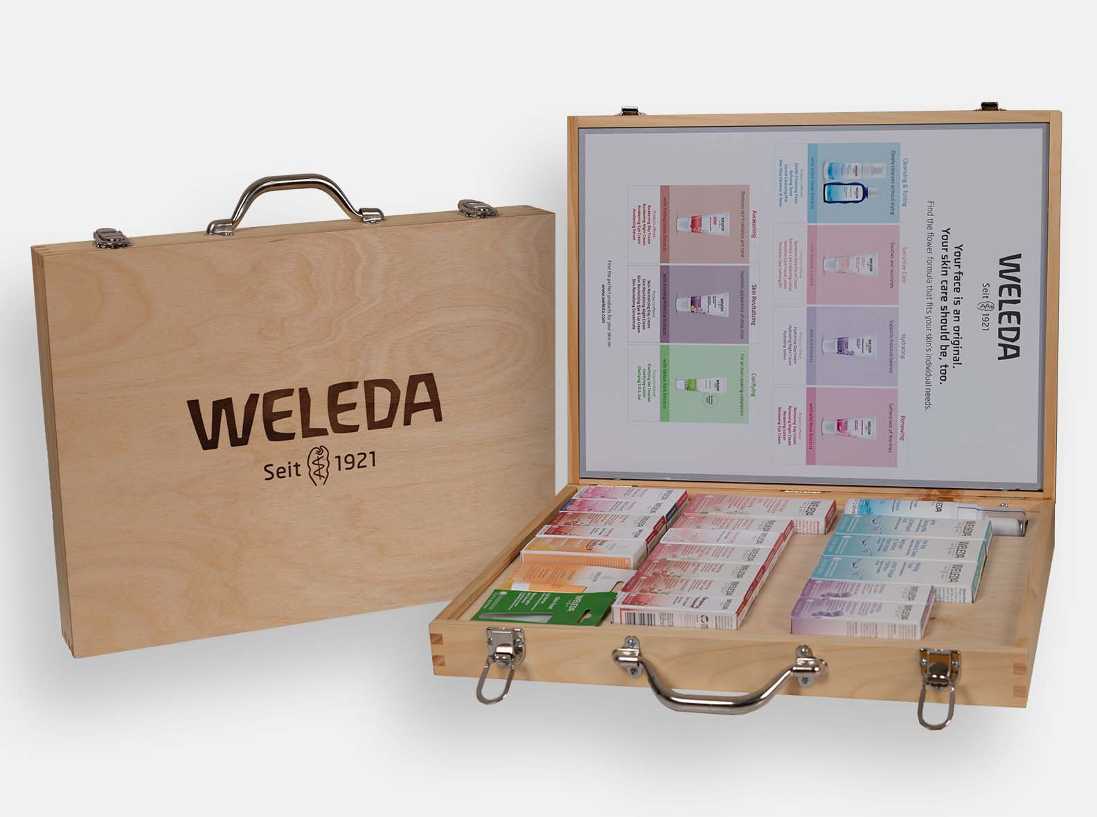 Wooden briefcase-style sales box with a metal handle, made for Weleda skincare.