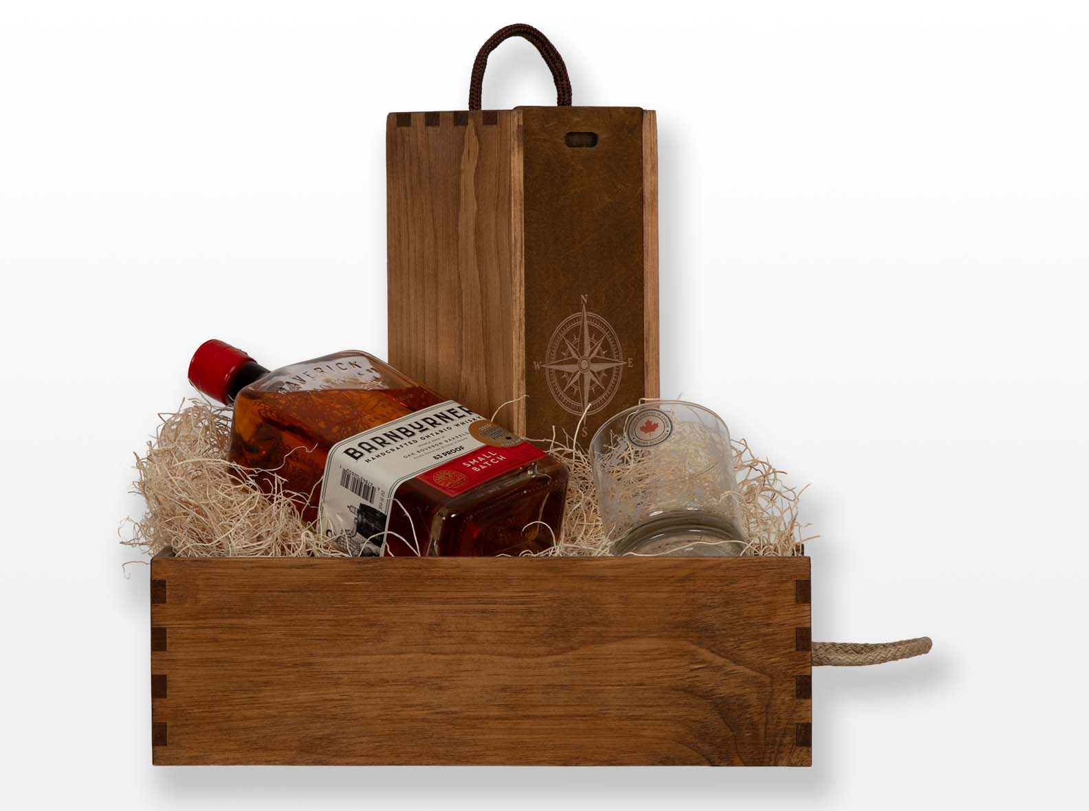 Pine gift box with walnut oil finish for bottle and glasses. Box joint construction. Sliding lid and wood excelsior. Made by Quintessential Canada Inc.